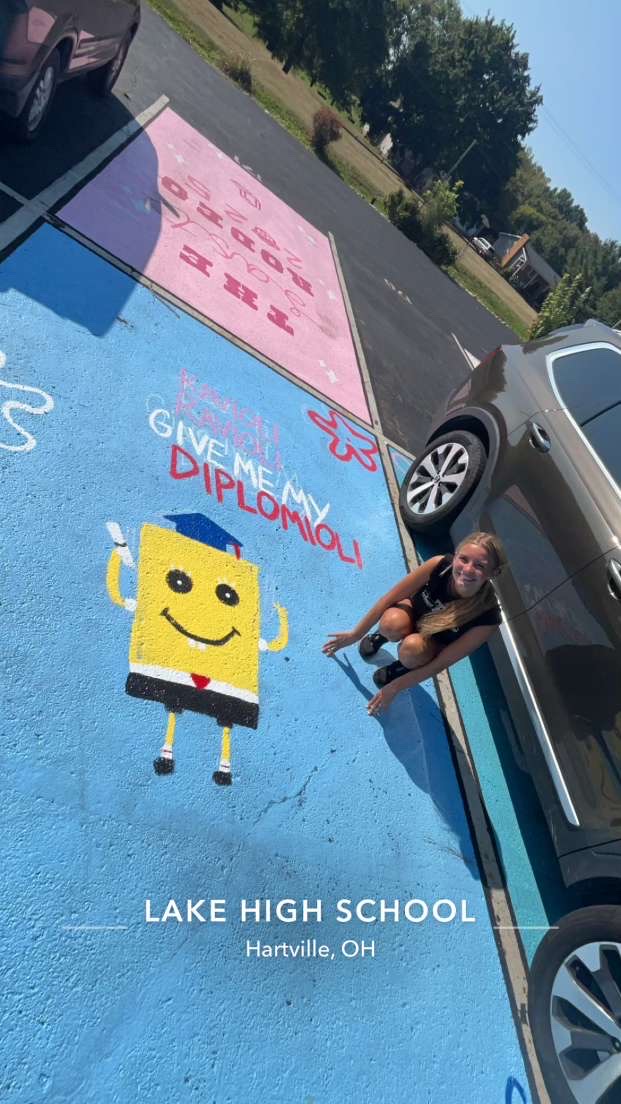 Leah Cooper stands over her parking spot design with a smile on Sunday Sept 8, 2024.