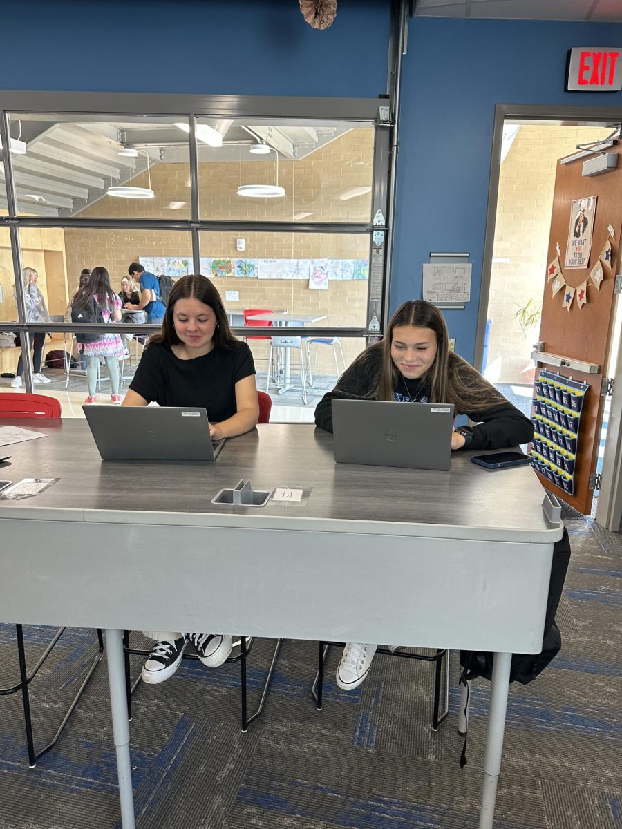 Students Megan Alcorn and Angelina Lisovets debating whether or not to use AI in class.